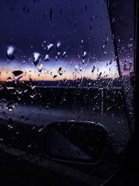 Close-up of wet glass window in rainy season