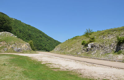 Scenic view of mountains against clear blue sky