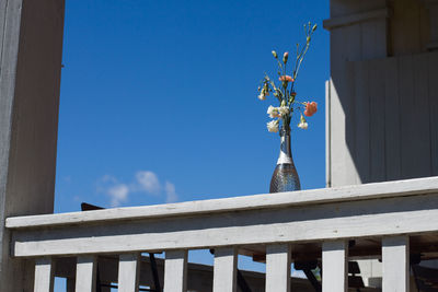 Low angle view of sculpture on building against blue sky