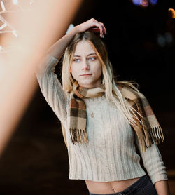 Thoughtful young woman standing at night