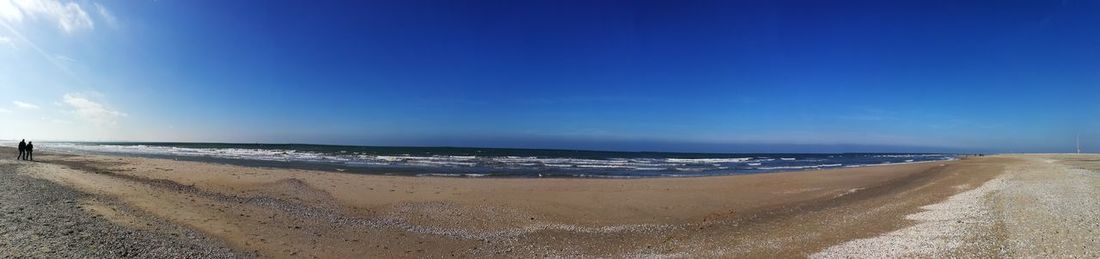 View of beach against blue sky