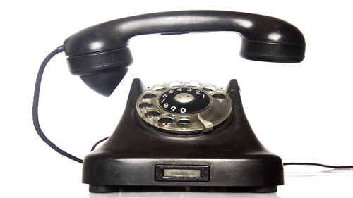 Close-up of telephone booth against white background