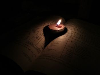 High angle view of lit candles on table