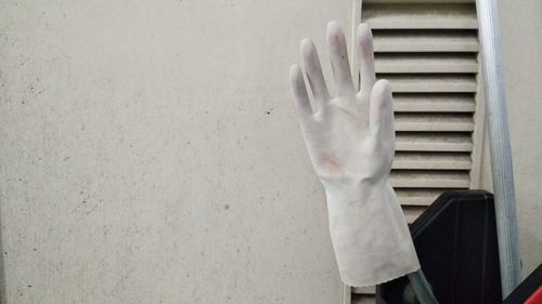 Close-up of hand on window of wall