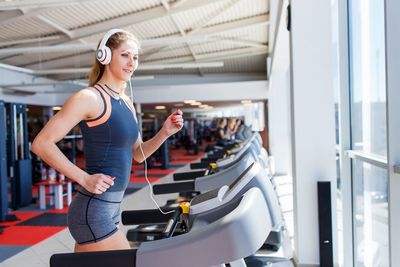 Young woman running on treadmill