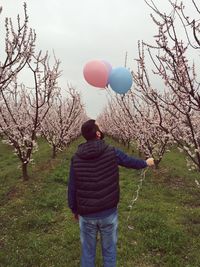 Woman playing with balloons in background