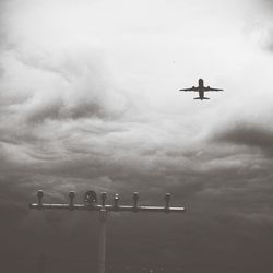 Low angle view of airplane flying in sky