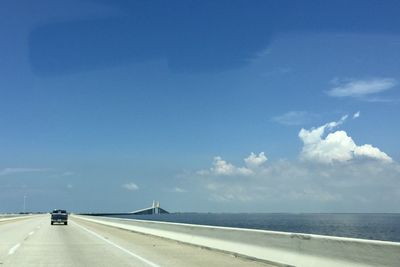 Road by sea against sky