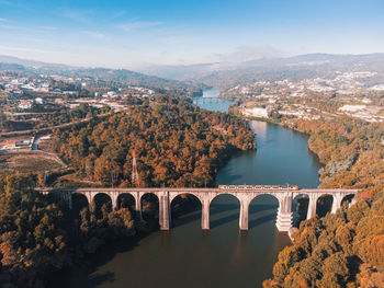 High angle view of bridge and a train over river against sky