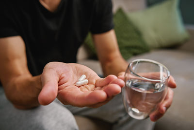 Midsection of man holding drink