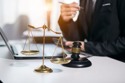 Close-up of man holding camera on table