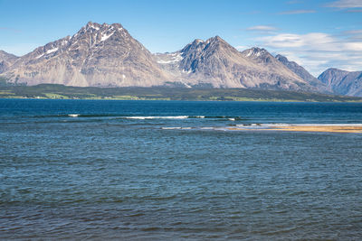 Scenic view of sea by lyngen alps against sky