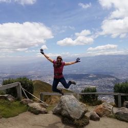 Woman standing on mountain against sky