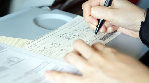 Midsection of man holding paper with text