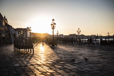 View of buildings in city at sunset