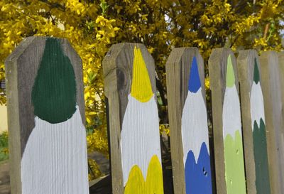 A wooden fence with painted on colorful crayons on the fencing