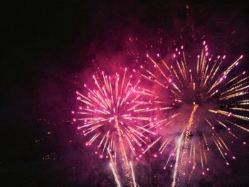 Low angle view of firework display at night