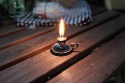 Close-up of burning candle on table