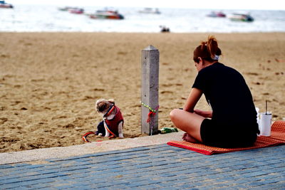 Rear view of mother and son on beach