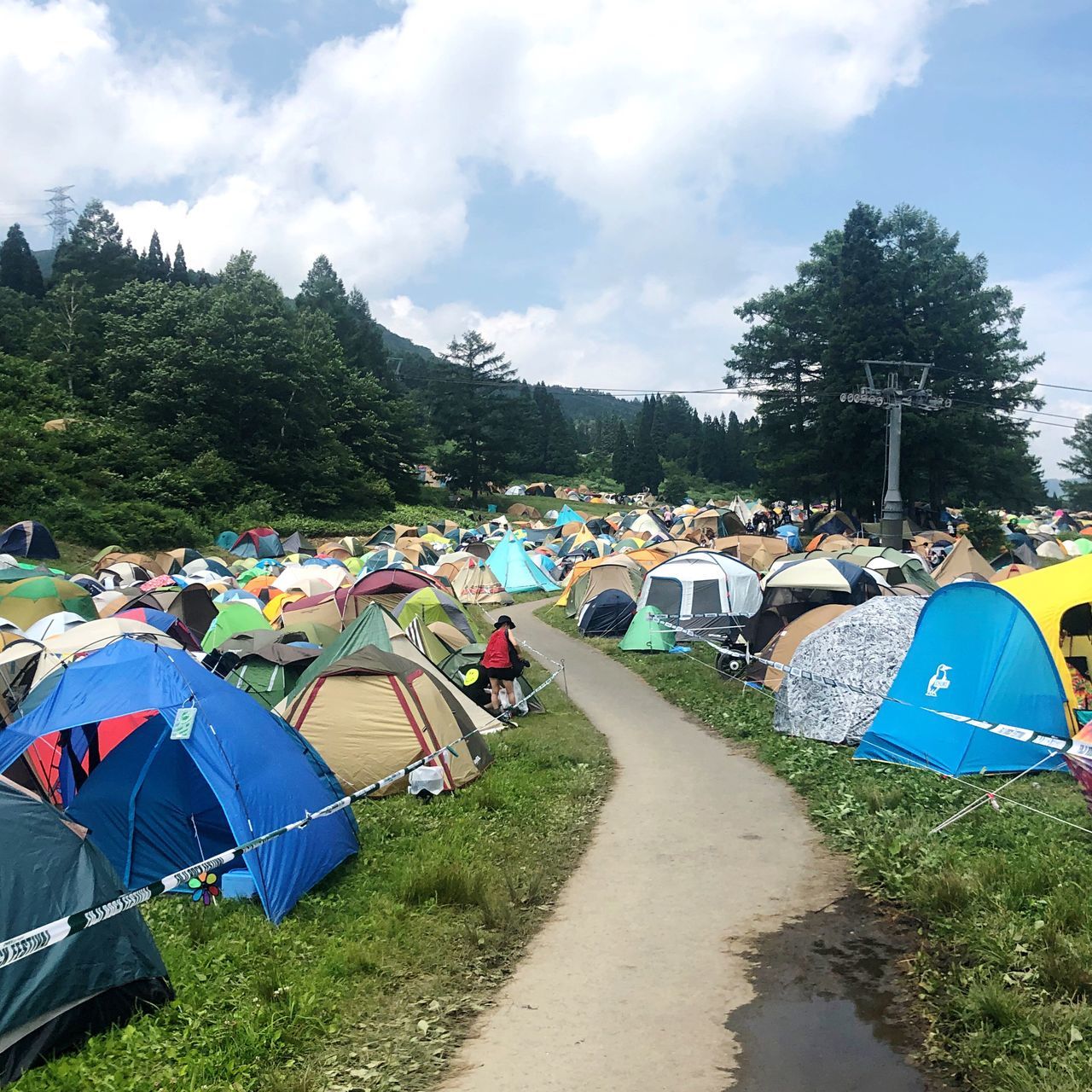 plant, tree, tent, sky, nature, cloud - sky, day, camping, group of people, grass, real people, people, transportation, men, land, leisure activity, crowd, adult, field, outdoors, festival