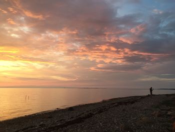 Scenic view of beach against sky during sunset