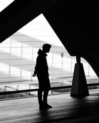 Silhouette man and woman walking in corridor