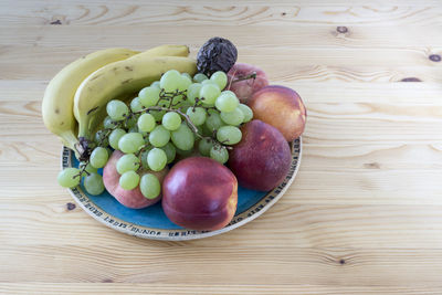 High angle view of grapes in plate on table