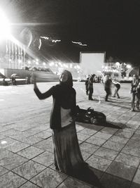 Blurred motion of woman in city at night