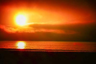 Scenic view of sea against romantic sky at sunset