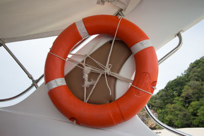 Low angle view of red wheel against sky