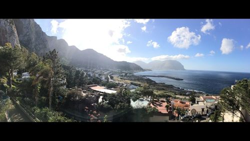 Scenic view of sea and mountains against sky