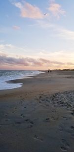 Scenic view of beach against sky during sunset