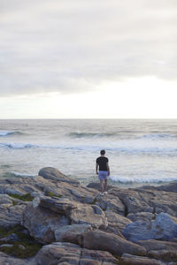 Man on beach looking at sea, cape of good hope, south africa