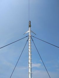 Low angle view of communications tower against sky