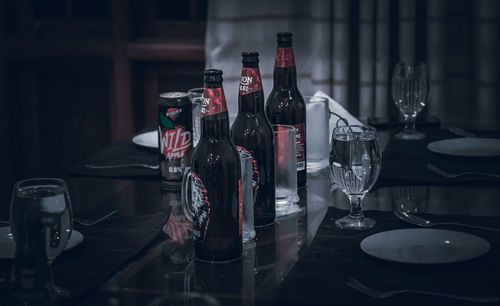 Empty bottles on table in restaurant
