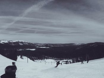 Tourists on snow covered mountain