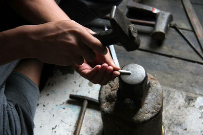 Cropped image of worker working at workshop