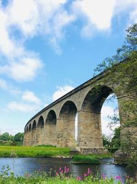 Low angle view of arch bridge against sky