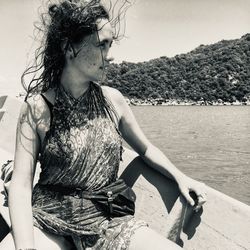 Woman looking away while sitting in boat