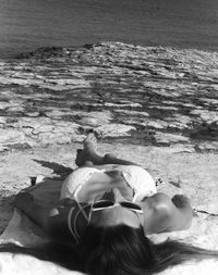 High angle view of woman lying on beach