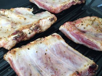 High angle view of ribs being roasted in griddle pan