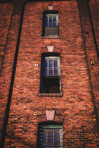 Low angle view of window on brick wall of building