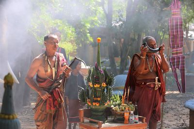 Men praying while standing outdoors