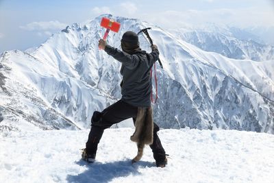 People skiing on snow covered landscape