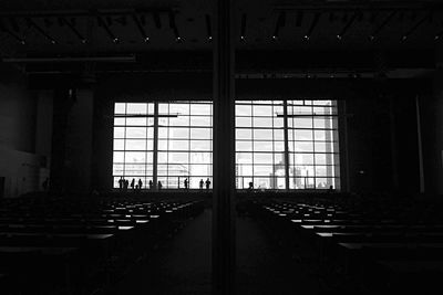 People by window in darkroom