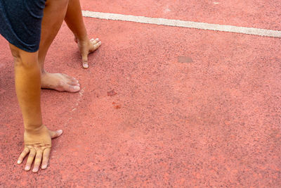 Low section of man on running track