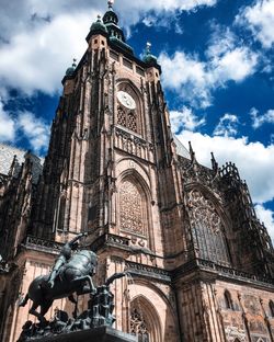 Low angle view of statue of cathedral against cloudy sky