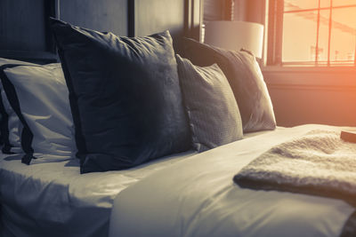 Midsection of man relaxing on bed at home