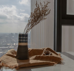 Close-up of glass bottle on table at home