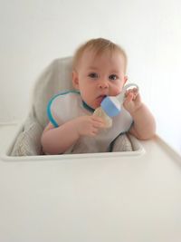 Portrait of cute baby girl sitting in stroller